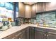 Close-up of kitchen featuring gray cabinets, elegant countertops, and modern coffee appliances at 1404 Richmond Rd, Lakeland, FL 33801