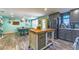 Open concept kitchen with gray cabinets, stainless appliances, and an island with butcher block countertop at 1404 Richmond Rd, Lakeland, FL 33801