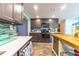 Stylish kitchen featuring gray cabinets, stainless steel appliances, and a charming wooden island at 1404 Richmond Rd, Lakeland, FL 33801