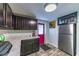 Cozy laundry room with gray cabinets, neutral floors, and a pink exterior door at 1404 Richmond Rd, Lakeland, FL 33801