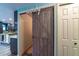 Stylish laundry room with sliding barn door and kitchen access at 1404 Richmond Rd, Lakeland, FL 33801