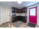 Well-lit laundry room with cabinets and a bright pink door at 1404 Richmond Rd, Lakeland, FL 33801