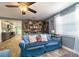 Inviting living room with a large window, cozy seating, and views into kitchen at 1404 Richmond Rd, Lakeland, FL 33801