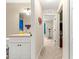 Bathroom with a single sink vanity and a hallway view featuring an excercise machine at 1553 Ne 161St Pl, Citra, FL 32113