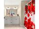 Bathroom showcasing a double sink vanity with shower featuring a floral curtain at 1553 Ne 161St Pl, Citra, FL 32113