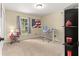 Room with carpet flooring featuring a desk, chair, large window, and American flag at 1553 Ne 161St Pl, Citra, FL 32113