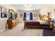 Spacious bedroom features a wooden bed frame, carpet flooring, and window with natural light at 1553 Ne 161St Pl, Citra, FL 32113