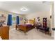 Bright bedroom showcases carpet flooring, large window, and classic wood furniture at 1553 Ne 161St Pl, Citra, FL 32113