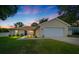 Charming single-story home boasting a manicured lawn, and a spacious two-car garage at 1553 Ne 161St Pl, Citra, FL 32113