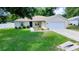 Charming single-story home featuring a well-maintained lawn and a convenient two-car garage at 1553 Ne 161St Pl, Citra, FL 32113