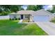 Charming single-story home featuring a well-maintained lawn and a convenient two-car garage at 1553 Ne 161St Pl, Citra, FL 32113
