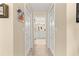 Hallway view looking into the bathroom, showcasing tile flooring and a white vanity at 1553 Ne 161St Pl, Citra, FL 32113