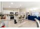 Open-concept living space with eat-in kitchen, stainless appliances, and comfortable living room at 1553 Ne 161St Pl, Citra, FL 32113