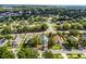 Inviting one-story home featuring a well-kept lawn and mature trees enhancing its curb appeal at 1584 Silhouette Dr, Clermont, FL 34711
