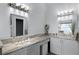 Bright bathroom with granite countertops, dual sinks, vanity space and modern lighting at 1584 Silhouette Dr, Clermont, FL 34711