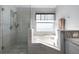 Modern bathroom featuring glass shower with a separate soaking tub and granite countertops at 1584 Silhouette Dr, Clermont, FL 34711