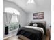 Bedroom with vaulted ceiling, large window, and neutral decor at 1584 Silhouette Dr, Clermont, FL 34711