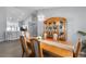 Bright dining room with wood furniture, elegant chandelier, and open view to the kitchen at 1584 Silhouette Dr, Clermont, FL 34711