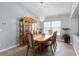 Traditional dining room with wood furniture, elegant chandelier, and plenty of natural light at 1584 Silhouette Dr, Clermont, FL 34711