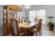 Traditional dining room with wood furniture, elegant chandelier, and plenty of natural light at 1584 Silhouette Dr, Clermont, FL 34711