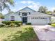 Charming home with a well-manicured lawn and an attached two-car garage at 1584 Silhouette Dr, Clermont, FL 34711
