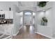Inviting foyer with an archway and wood-look flooring leading into the house at 1584 Silhouette Dr, Clermont, FL 34711
