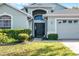 Inviting front entrance with lush landscaping and a well-maintained lawn at 1584 Silhouette Dr, Clermont, FL 34711