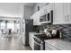 Modern kitchen featuring white cabinets, stainless steel appliances, and eat-in dining area at 1584 Silhouette Dr, Clermont, FL 34711