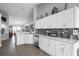 Bright kitchen featuring white cabinetry, granite countertops, and stainless steel appliances at 1584 Silhouette Dr, Clermont, FL 34711