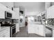 Well-designed kitchen with white cabinets, stainless steel appliances, and open layout at 1584 Silhouette Dr, Clermont, FL 34711