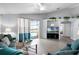 Relaxing living room with luxury vinyl plank flooring, light walls, and views through sliding glass doors to the pool area at 1584 Silhouette Dr, Clermont, FL 34711