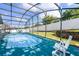 Relaxing screened-in pool area with white furniture for lounging and entertaining at 1584 Silhouette Dr, Clermont, FL 34711