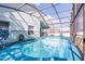 Back of the house with screened-in pool, fenced yard, and outdoor seating area at 1584 Silhouette Dr, Clermont, FL 34711