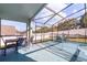 Covered patio features an outdoor dining area and a view of the pool and fenced backyard at 1584 Silhouette Dr, Clermont, FL 34711