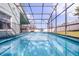 Back of the house with screened-in pool, fenced yard, and outdoor seating area at 1584 Silhouette Dr, Clermont, FL 34711
