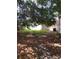 A large backyard with mature trees. Side view of the home with an AC unit next to it at 2426 Maple Ave, Sanford, FL 32771