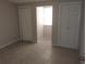 Cozy bedroom featuring neutral walls, tiled floor, and ample closet space at 2426 Maple Ave, Sanford, FL 32771