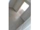 Hallway featuring tile floors and a light streaming through the window at 2426 Maple Ave, Sanford, FL 32771