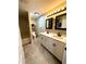 Updated bathroom featuring double sinks, black fixtures, decorative mirrors and tile flooring at 2550 Sw Ivy Pl, Dunnellon, FL 34431