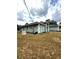 Home exterior featuring well-maintained landscaping, backup generator, and neutral color palette at 2550 Sw Ivy Pl, Dunnellon, FL 34431