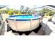 Backyard featuring a sparkling above ground pool with ladder at 2550 Sw Ivy Pl, Dunnellon, FL 34431