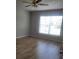 Bright bedroom features wood-look floors, ceiling fan, and window letting in natural light at 3223 Sw 41St Ave, Ocala, FL 34474