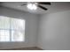 Bright bedroom features wood-look floors, ceiling fan, and a window letting in natural light at 3223 Sw 41St Ave, Ocala, FL 34474