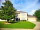 Charming two-story home with a well-manicured lawn and beautiful landscaping at 3223 Sw 41St Ave, Ocala, FL 34474