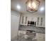 Stylish kitchen features white cabinets, granite counters, tile backsplash, and modern appliances at 3223 Sw 41St Ave, Ocala, FL 34474