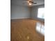 Spacious living room with laminate floors, ceiling fan and large windows for natural light at 3223 Sw 41St Ave, Ocala, FL 34474