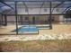 View of the backyard, home, and screened pool area at 3223 Sw 41St Ave, Ocala, FL 34474