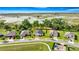 Aerial view of homes featuring mature trees, green lawns, and picturesque water views in a quiet neighborhood at 358 Irving Bend Dr, Groveland, FL 34736