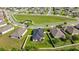 Aerial view of homes featuring mature trees, green lawns, and picturesque water views in a quiet neighborhood at 358 Irving Bend Dr, Groveland, FL 34736