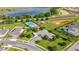 Aerial view showcasing the community pool, playground, and surrounding landscape at 358 Irving Bend Dr, Groveland, FL 34736